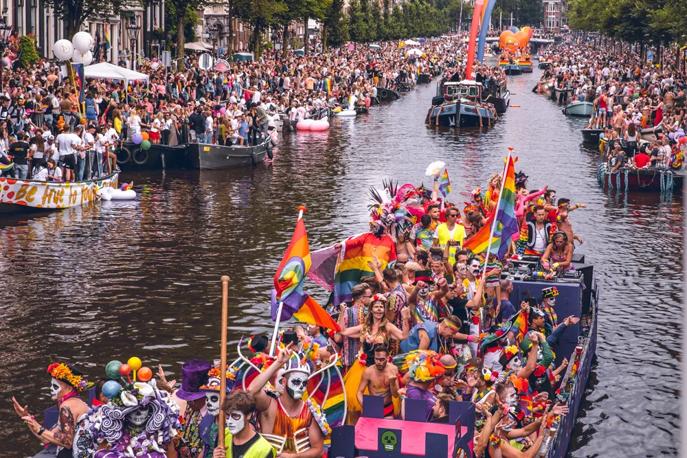 Amsterdam Pride Canal Parade - colorful boats navigating the historic city canals