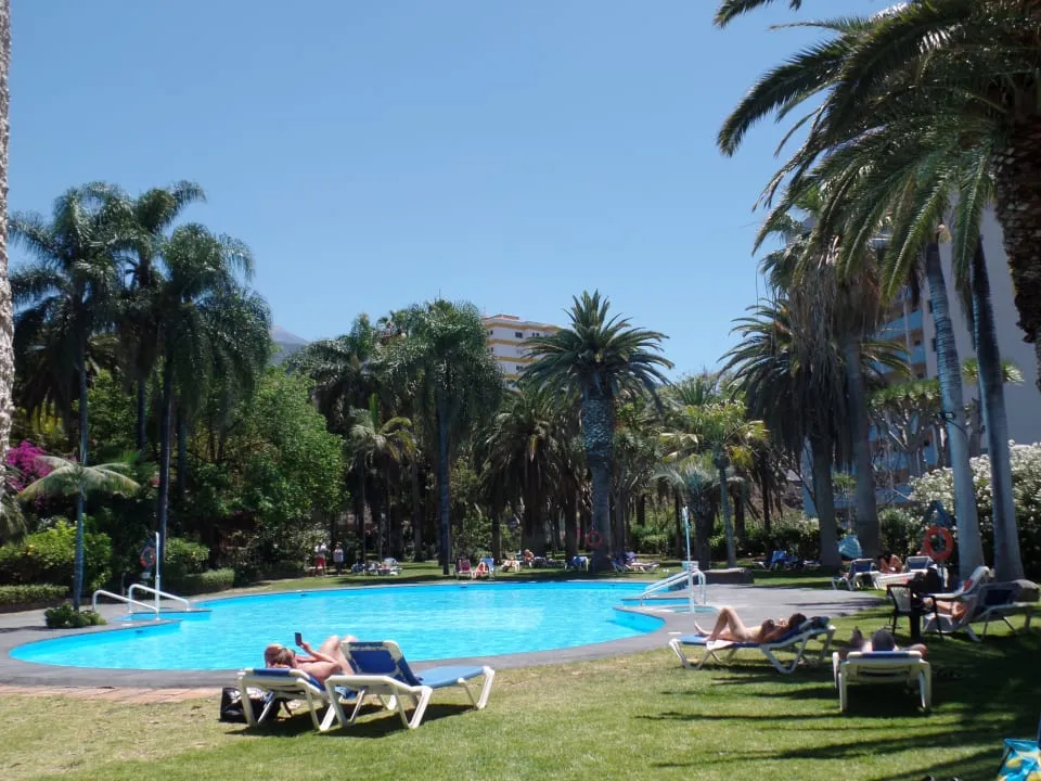 Tenerife luxury resort - sun-drenched pool area and palm trees for winter sun
